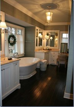 a large white bath tub sitting inside of a bathroom