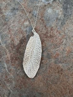 Unique handmade silver pendant from a Viburnam leaf, from East Sussex, England. Comes with an 18 inch sterling silver chain and a box. Please note the pendant is unhallmarked, fine silver. Handmade Silver Leaf-shaped Necklace, Handmade Sterling Silver Leaf Necklace, Silver Leaf-shaped Nature-inspired Necklace, Silver Leaf-shaped Sterling Silver Necklace, Handmade Sterling Silver Leaf-shaped Necklace, Handmade Silver Leaf Jewelry, Silver Leaf-shaped Necklace Gift, Silver Leaf-shaped Necklaces For Gift, Silver Leaf-shaped Necklace For Gift