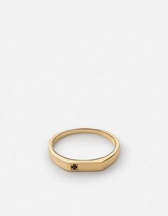 a gold ring with a black diamond on it