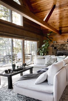 a living room filled with furniture and a fire place next to a large glass door