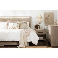 a bedroom with a bed, dresser and night stand