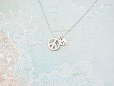 Personalized silver peace sign necklace. Choose letter/initial from the drop-down list above. This elegant peace sign has a smooth semi matte/satin finish, and hangs on a fine dainty chain.DETAILS :* Tiny peace charm measures 1/3" (9mm)* Chain length is 18 inches (45cm) * I am always happy to make your chain longer or shorter, free of charge. Simply write a note at the checkout. Your Zoe River jewelry will arrive gift-wrapped and in a sweet little organza giftbag, carefully packaged to arrive sa River Jewelry, Cat Necklace Gold, Peace Necklace, Peace Sign Necklace, Mother Daughter Necklace, Sign Necklace, Silver Mermaid, Daughter Necklace, Dainty Chain