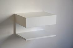 two white shelves against a white wall