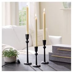 three candles are sitting on a coffee table