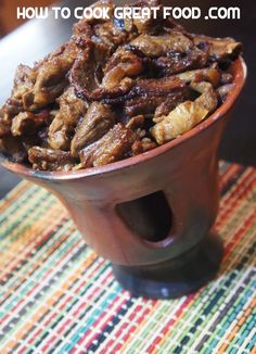 a bowl filled with food sitting on top of a table