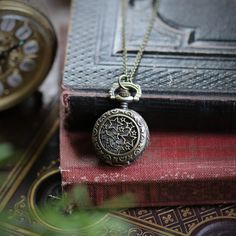 Small 25mm pocket watch necklace with a high quality quartz movement inside.On 28 inches of antiqued brass chain. If you'd like a chain that has 2 little Victorian birds attached like I have pictured in some of my other watch listings, then just select that option at checkout.I can make this chain any length for no extra charge. Just leave me a note at checkout!You can adjust the time by pulling up the knob and turning.Pressing the knob opens the watch.Each watch comes with an extra battery and Pocket Watch Aesthetic, Pinwheel Galaxy, Pocket Watch Necklace, Simple Chain, Vintage Pocket Watch, Pocket Watch Chain, Watch Chain, Watch Necklace, Brass Chain