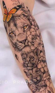 a woman's arm with a lion and flowers on it