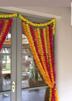 the door is decorated with flowers and garlands