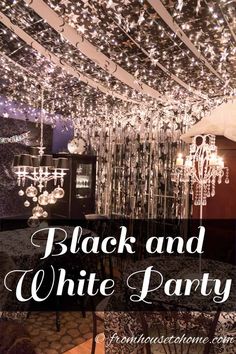 a black and white party with chandeliers hanging from the ceiling