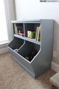 a book shelf with two bins on top of it in the corner of a room