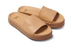 Chick leather platform slide sandals in beach - angle shot Leather Open Toe Platform Slippers With Cushioned Footbed, Summer Leather Platform Slippers With Leather Footbed, Chic Platform Slippers With Leather Footbed, Comfortable Leather Platform Slippers With Cushioned Footbed, Leather Platform Slide Slippers With Rubber Sole, Leather Slide Platform Slippers With Rubber Sole, Leather Open Toe Platform Slippers With Leather Footbed, Comfortable Leather Platform Slippers For Summer, Chic Platform Slippers With Leather Footbed And Round Toe