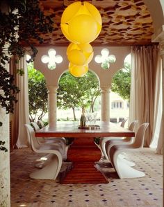 the dining room is decorated in white and yellow