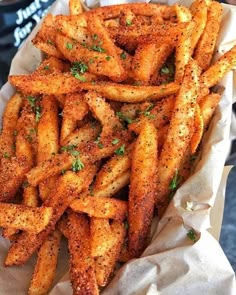 french fries with seasoning on top in a basket