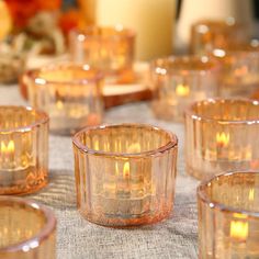 many small glass candles are on the table