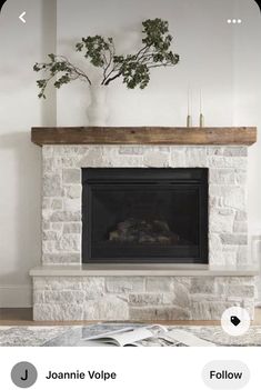 a living room with a fire place and a glass table in front of the fireplace