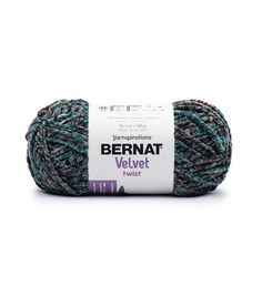 bernat velvet twist yarn ball in blue and green, sitting on a white surface