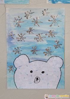 a paper cut out of a polar bear with snowflakes on it's head