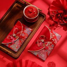 a red table topped with plates and napkins