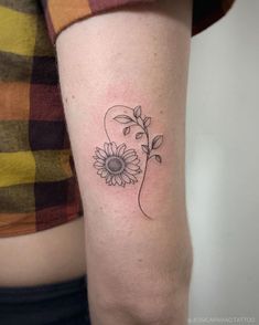 a woman's arm with a tattoo on it and a flower in the middle