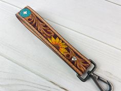 a leather key fob with a sunflower on it