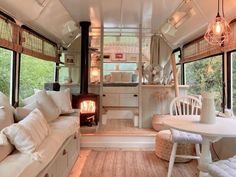 a living area with couches, chairs and a fire place in the middle of it