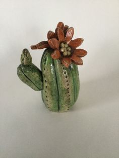 a ceramic cactus with a flower on it