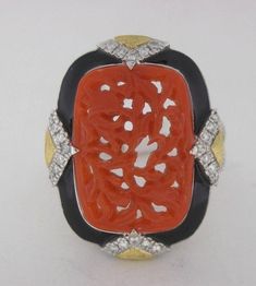 A Vintage Platinum and Brushed 18k Yellow Gold Ring. With a Hand Carved Exceptional Coral That Weighs 5.90ct, Measuring 17.6x12.6mm. 60 Diamonds=0.38ctw G/VS2, Respectively. Finished with Shiny Black Enamel. This Gorgeous Ring Weighs 9.8 Grams. Elegant Enamel Ring With Inlay, Elegant Enamel Ring With Inlay For Anniversary, Luxury Inlay Rings For Anniversary, Luxury Enamel Ring, Luxury Carved Rings, Luxury Multi-stone Enamel Ring As Gift, Luxury Multi-stone Enamel Ring For Gift, Luxury Hallmarked Enamel Ring For Anniversary, Luxury Hallmarked White Gold Enamel Ring