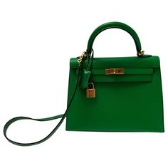 Hermes Bamboo Kelly 25 Bag. Excellent like new condition. Interior clean. Plastic is still on the hardware. Most wanted size Kelly. Rare small size. Includes clochette, lock, keys, and dust bag. Guaranteed authentic. Classic Green Satchel With Branded Hardware, High-end Shopping Bags With Lock, Green Satchel With Palladium Hardware, Green Satchel With Palladium Hardware And Top Handle, Green Top Handle Bag With Palladium Hardware, Luxury Green Bag With Lock, Luxury Green Bags With Lock, Green Office Bag With Branded Hardware, Formal Green Bag With Branded Hardware