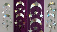 three metal stars and crescents hanging from the side of a purple wall next to each other