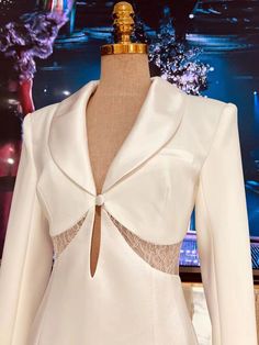 a mannequin wearing a white dress and jacket