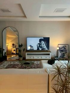 a living room filled with furniture and a flat screen tv