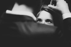 black and white photograph of a woman reading a book with her hands on her head