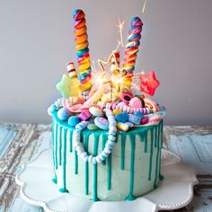 a birthday cake decorated with colorful candies and sparklers