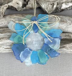 a piece of driftwood with sea glass on it