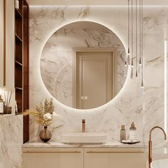 a bathroom with marble counter tops and a round mirror