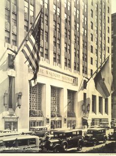 an old black and white photo of cars in front of the wall street station building