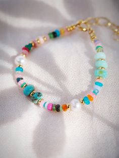 This modern mixed rainbow gemstone and pearl bracelet is a must have. The elegant mix of pearls and gemstones including opals, turquoise, quartz and more make this beaded bracelet versatile and an instantaneous favorite.✦ DETAILS ✦✧ Name: Kainui (kaee NOO ee) - big sea, great sea.✧ Mixed Gemstones and Freshwater Pearls.✧ Adjustable fit 6"-8" inches.✧ 14kt Gold Filled components and clasp.✧ All Ke Aloha Jewelry pieces come packaged thoughtfully, beautifully, and ready for gift giving.✧ Unless oth Bohemian Bracelets With Colorful Pearl Beads, Bohemian Pearl Bracelets With Colorful Beads, Multicolor Pearl Beaded Bracelets In Bohemian Style, Bohemian Multicolor Pearl Beaded Bracelets, Multicolor Pearl Beaded Bohemian Bracelets, Turquoise Beaded Pearl Bracelets, Multicolor Handmade Pearl Bracelet For Beach, Rainbow Gemstone Beads Bracelets, Multicolor Pearl Bracelet With Gemstone Beads