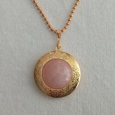 "Photo necklace for women.  Rounded picture locket with rose quartz cabochon.  Photo locket necklace. Vintage locket. Picture necklace gift   This necklace measures 29\" inches in length Fit 20 mm I include always a free surprise gift with every order All items are wrapped individually in a gift box Shipment arrives in 4 week by registered mail Contact me with any questions or requests, I'd be happy to help" Pink Locket Jewelry Gift, Gold Rose Quartz Round Pendant Jewelry, Pink Medallion Jewelry As A Gift, Pink Medallion Jewelry Gift, Pink Medallion Jewelry For Gifts, Pink Medallion Necklace For Gifting, Pink Cabochon Necklaces For Gift, Pink Amulet Necklace For Gift, Locket Picture