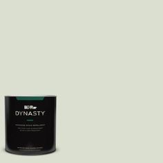 a can of behr marquee paint on a green background