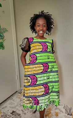 This African-print A-line dress with puff sleeves is so cute and bright. The vibrant colors and patterns  will make your little girl stand out uniquely and beautifully.  It can be worn for any occasion, whether it's a birthday or wedding party, church, or other special occasion. Dress is also great for an African culture themed event. It's designed with comfortable materials that will keep your little girl feeling fresh and beautiful all day long. - Taffeta elastic band sleeve - Pleated hemline Playful Multicolor Print Short Sleeve Dress, Playful Short Sleeve Multicolor Print Dress, Multicolor Printed Puff Sleeve Dress, Green Cotton Puff Sleeve Dress, Multicolor Puff Sleeve Printed Dress, Green Cotton Puff Sleeve Short Dress, Playful Green Printed Dress, Short Sleeve Dresses With Mixed Print, Short Sleeve Multicolor Print Patchwork Dress