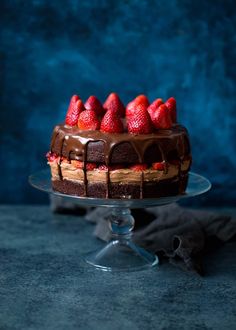 a cake with chocolate icing and strawberries on top