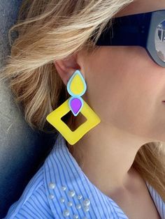 A unique pair of Clip On Earrings with colorful plexiglass parts in rhombus shape. The main color is yellow, light blue and fuchsia and the materials I use are plexiglass parts and metal clip ons in silver color. They open and close with clip on. In Christina Christi Jewels store you can see a lot of designs in Women's Earrings. You can have them in 2-4 Days with DHL EXPRESS SHIPPING MATERIALS - Metal parts. - Plexiglass parts. DIMENSIONS - Total length of Earrings: 8.5 cm (3.3'') - Total width Trendy Yellow Earrings, Trendy Bold Design Earrings As Gift, Trendy Bold Design Earrings For Gifts, Modern Yellow Earrings For Party, Unique Yellow Earrings For Party, Bold Multicolor Jewelry For Pierced Ears, Trendy Multicolor Drop Plug Earrings, Bold Drop Earrings With Bold Design, Modern Yellow Dangle Earrings