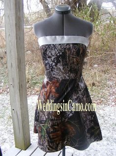 a dress made out of realtree camo on a mannequin stand in the snow