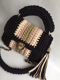 a black and white purse with tassels on it