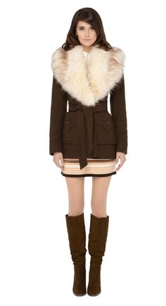 Immediately striking seventies winter jacket with indistinguishable from the real thing cruelty free cream oversized faux fur collar, top stitched deep essentials front pockets and belt closure.   Cozy, comfy and cool.  Pairs well with our 1970s Style Jersey Dress to complete the look.  Unsure of your size? Use our chat feature. Fitted Winter Outerwear With Belted Cuffs, Chic Winter Outerwear With Belted Cuffs, Beige Winter Outerwear With Belted Cuffs, Winter Collared Outerwear With Belted Cuffs, Belted Brown Outerwear For Winter, Winter Belted Outerwear For Cold Weather, Belted Long Sleeve Fur Coat For Fall, Winter Outerwear With Belt For Cold Weather, Fall Fur Coat With Padded Collar For Cold Weather