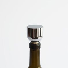 a wine bottle with a metal stopper on it's top is shown in front of a white background