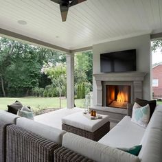 a living room with couches and a fire place in the middle of the room