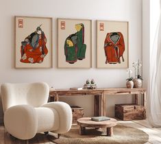 three paintings hang on the wall above a white chair