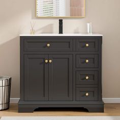 a bathroom vanity with a mirror above it and a trash can in front of it