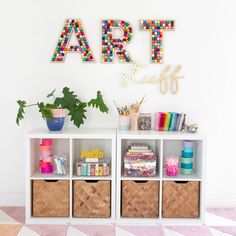 an art display with craft supplies and letters on the wall above it, along with other crafts